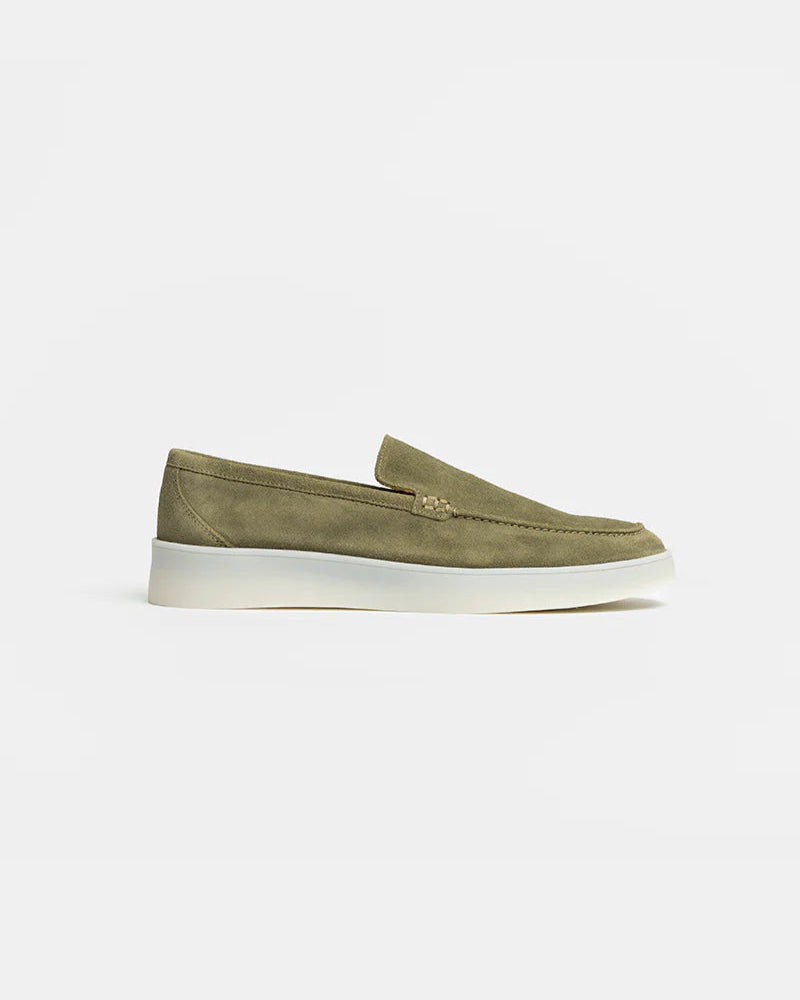 Green loafer shoe on a white background
