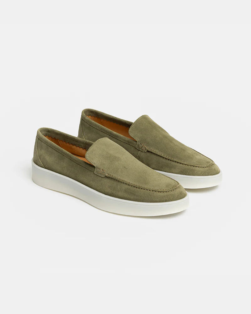 Pair of green loafers on a white background