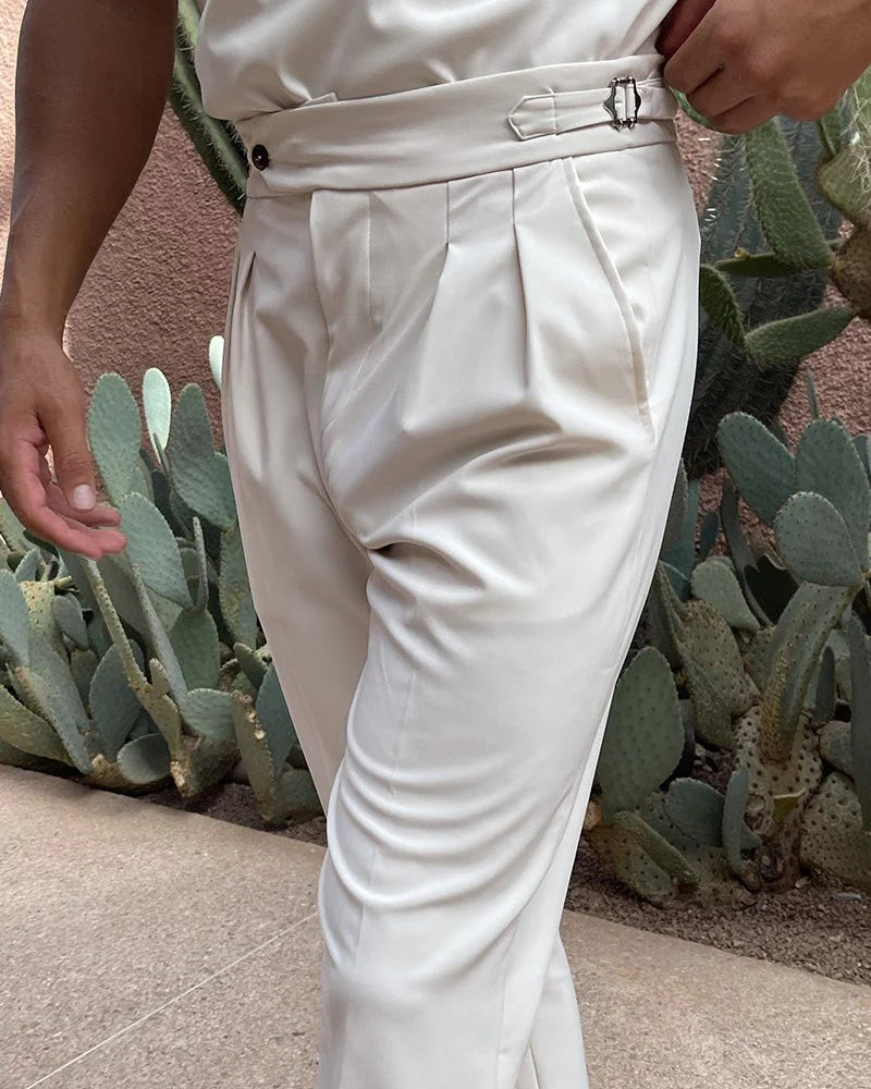 White pants worn by a person with cacti in the background